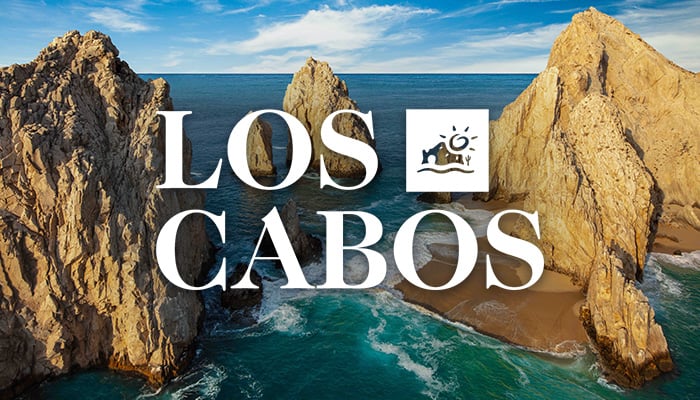 Rock formations rising in the ocean, with the Los Cabos logo overlaid.